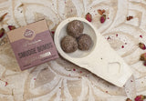 Smudge bombs in a bowl with packaging on a decorative surface
