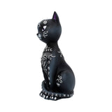 Black cat figurine with white tattoos on a white background