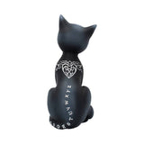 Black cat figurine with white designs on a white background