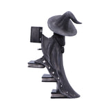 Decorative figurine of a witch on a broomstick with stars on a white background