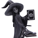 Black witch figurine with a hat and robe holding a book on a white background