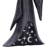Statue of a figure in a dark robe with celestial designs on a white background