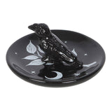 Black ceramic ring dish with a bird design on a white background