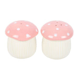 Two mushroom-shaped salt and pepper shakers with pink caps and white stems on a white background.