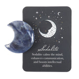 Sodalite crystal half-moon stone on a black card with celestial design and text.