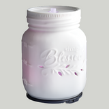White mason jar-shaped candle warmer with 'Blessed' text on a white background