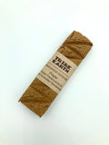 A single incense plank with a label that reads 'TRIBE EARTH - Handmade Incense - Sandalwood & Frankincense'.