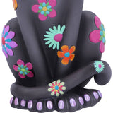 Black elephant figurine with colorful flowers on a white background