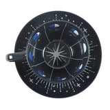 Black ceramic plate with moon phase design on a white background