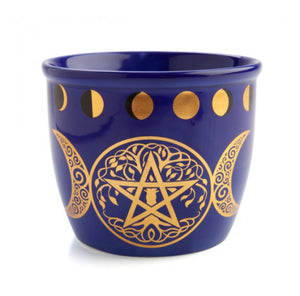 Blue cup with gold pentagram and moon phases design on a white background