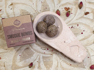 Smudge bombs in a dish with packaging on a decorative surface