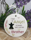Memorial plaque with text 'I have an angel in heaven and I call him my brother' on a floral background.