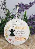 Round white plaque with text and silhouette of a person, surrounded by purple flowers and greenery.