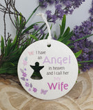 Memorial ornament with text 'I have an Angel in heaven and I call her My Wife' against a floral background.