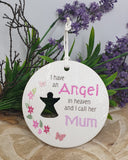 Decorative plaque with text 'I have an Angel in heaven and I call her Mum' against a floral background.