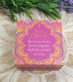 Decorative box with motivational quote on a natural stone surface