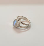 Silver ring with a stone on a light gray background