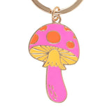 Mushroom-shaped keychain with pink cap and yellow stem on a white background