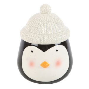 Ceramic penguin with a white knit hat on a white background
