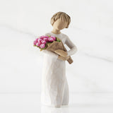 Decorative figurine of a person holding flowers on a white background