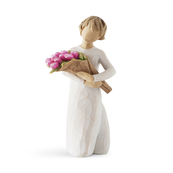 Figurine of a person holding tulips on a white background