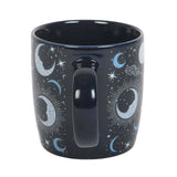 Black mug with celestial design featuring moons and stars on a white background