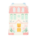 Toy house with pink roof and white body on a white background