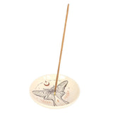 Incense stick on a decorative ceramic holder with butterfly design on a white background