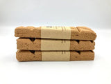 Three stacked cork boards with kraft paper wrapping on a white background