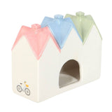 Pastel-colored pet house with a small bicycle and bird design on a white background