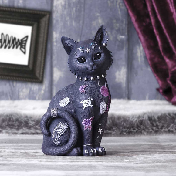 Decorative black cat figurine with tattoos on a wooden surface