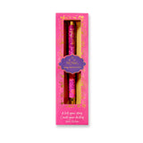 Decorative pen in a pink box with floral patterns on a white background