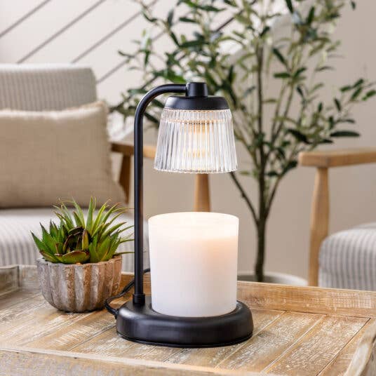 Decorative lamp with candle on a wooden table outdoors