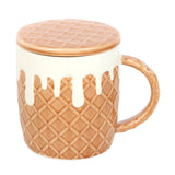 Mug with waffle-patterned lid and handle on a white background