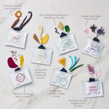 Various Aroma Ajna diffuser bags with floral and botanical elements on a light background