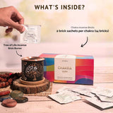 Chakra incense kit with incense bricks, brick burner, and packaging on a wooden surface.