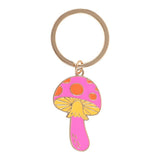 Mushroom-shaped keychain with pink cap and yellow stem on a white background
