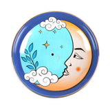 Decorative plate with a moon face, clouds, and stars on a blue background