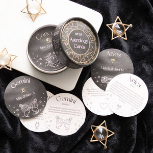 Astrology cards with zodiac signs on a dark surface