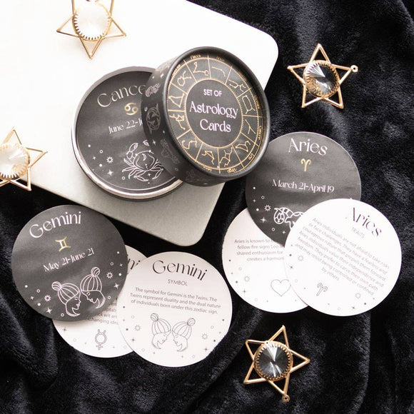 Astrology cards with zodiac signs on a dark surface