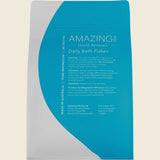 Package of Amazing Health Restored Daily Bath Flakes on a beige background