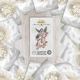Card featuring an angelic figure surrounded by white envelopes with gold symbols on a wooden surface