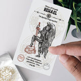 Card featuring an angel with a sword held by a hand, with a plant in the background