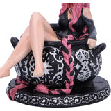 Statue of a person sitting in a decorative chair with pink hair and black and white patterned design.