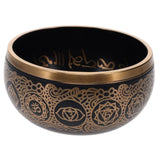 Decorative bowl with gold patterns on a black background