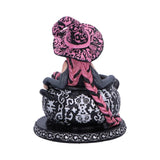 Decorative figurine with pink and black hair in a bun on a white background