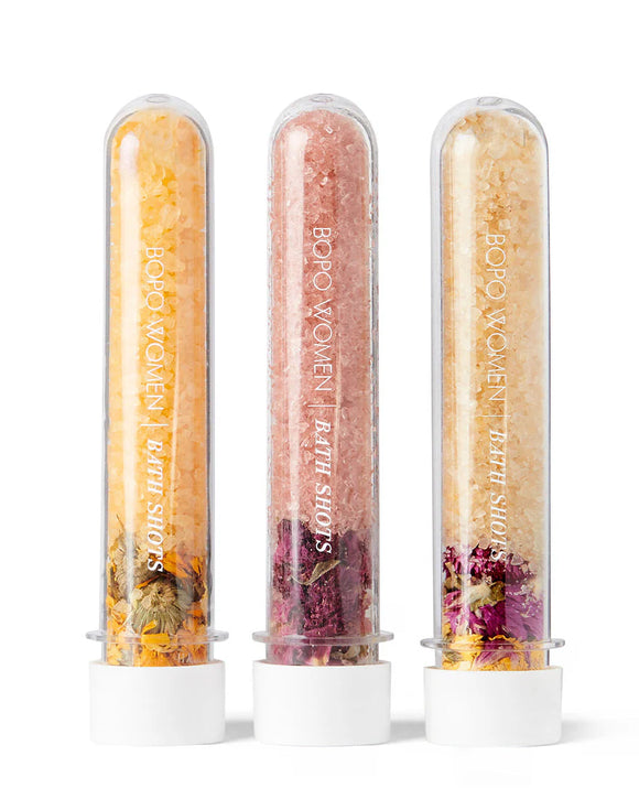 Three transparent tubes filled with colorful contents on a white background, featuring the brand 'BOPo Women