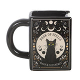 Black mug with a cat and celestial design, featuring text 'Book of Spells' and 'Magick Cat Energy'.