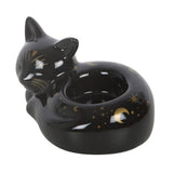 Black cat-shaped candle holder with star and moon designs on a white background