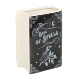 Decorative book-shaped container with 'Book of Spells' text and a raven illustration on a white background.